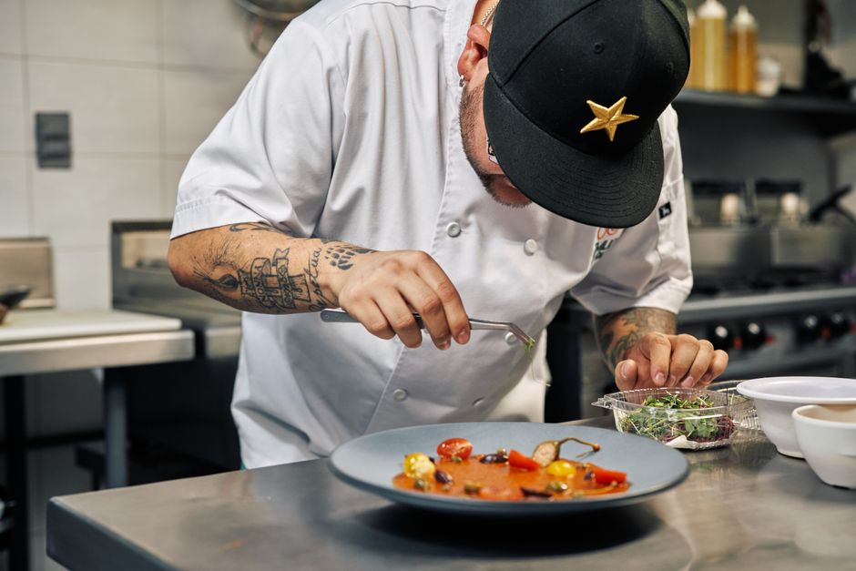 Chef meticulously plating a gourmet dish